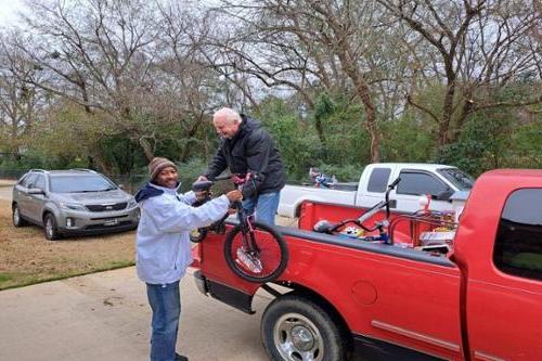 Servant Scholars Director gifts bike to community leader